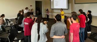 Students in a circle playing coco