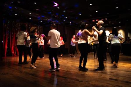 Group dancing Tango in a dimly lit room